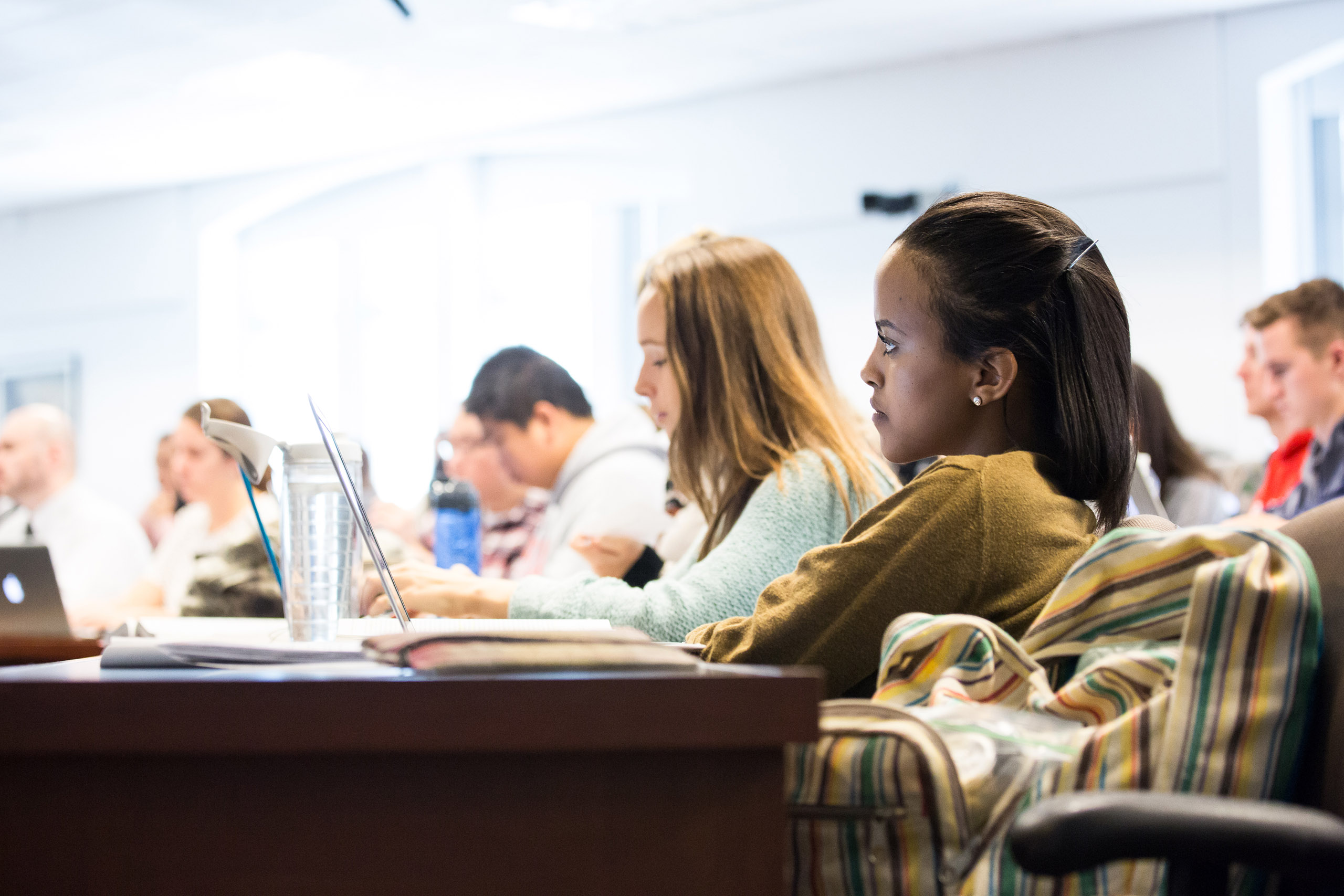 students in a lecture hall listening intently