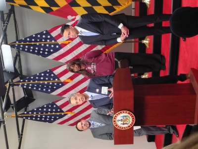 Michael Pinard standing at a podium during a press conference