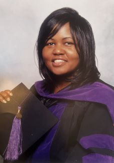Headshot of person in law school graduation regalia