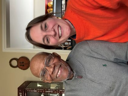Two people posed together indoors smiling