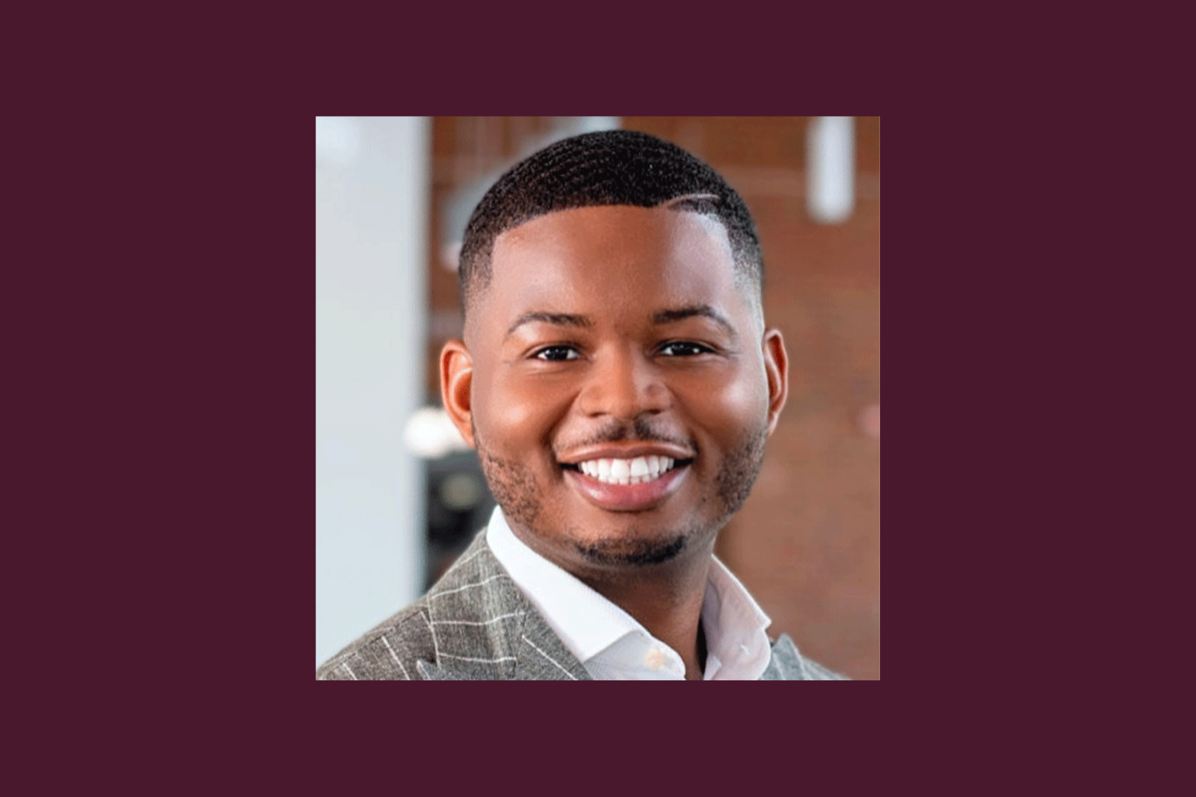 Headshot of Christopher Mathis against a maroon background.