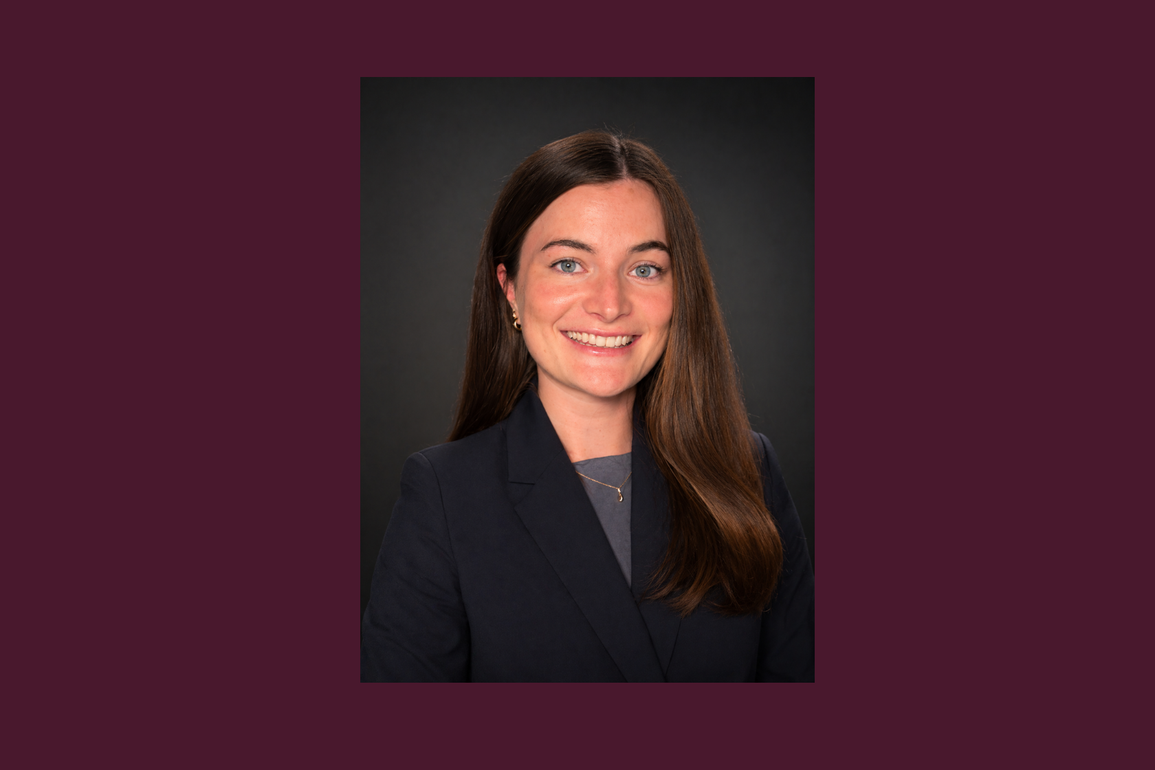 Headshot of person smiling in business attire